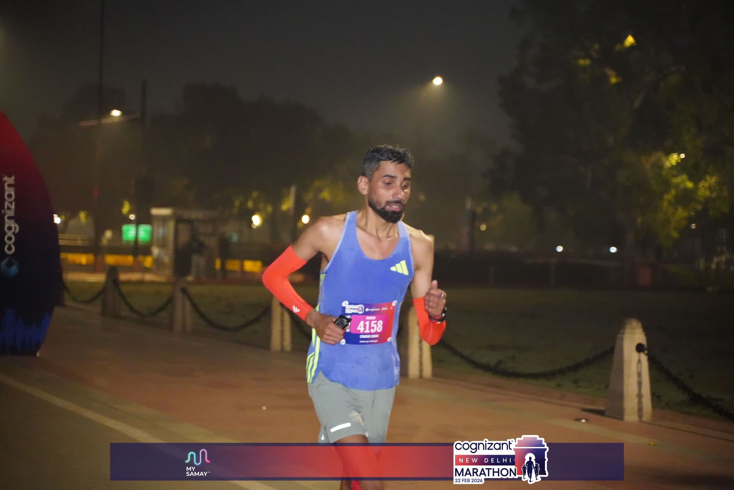 Charan Singh racing the Cognizant New Delhi Marathon 2026 at night, bib 4158