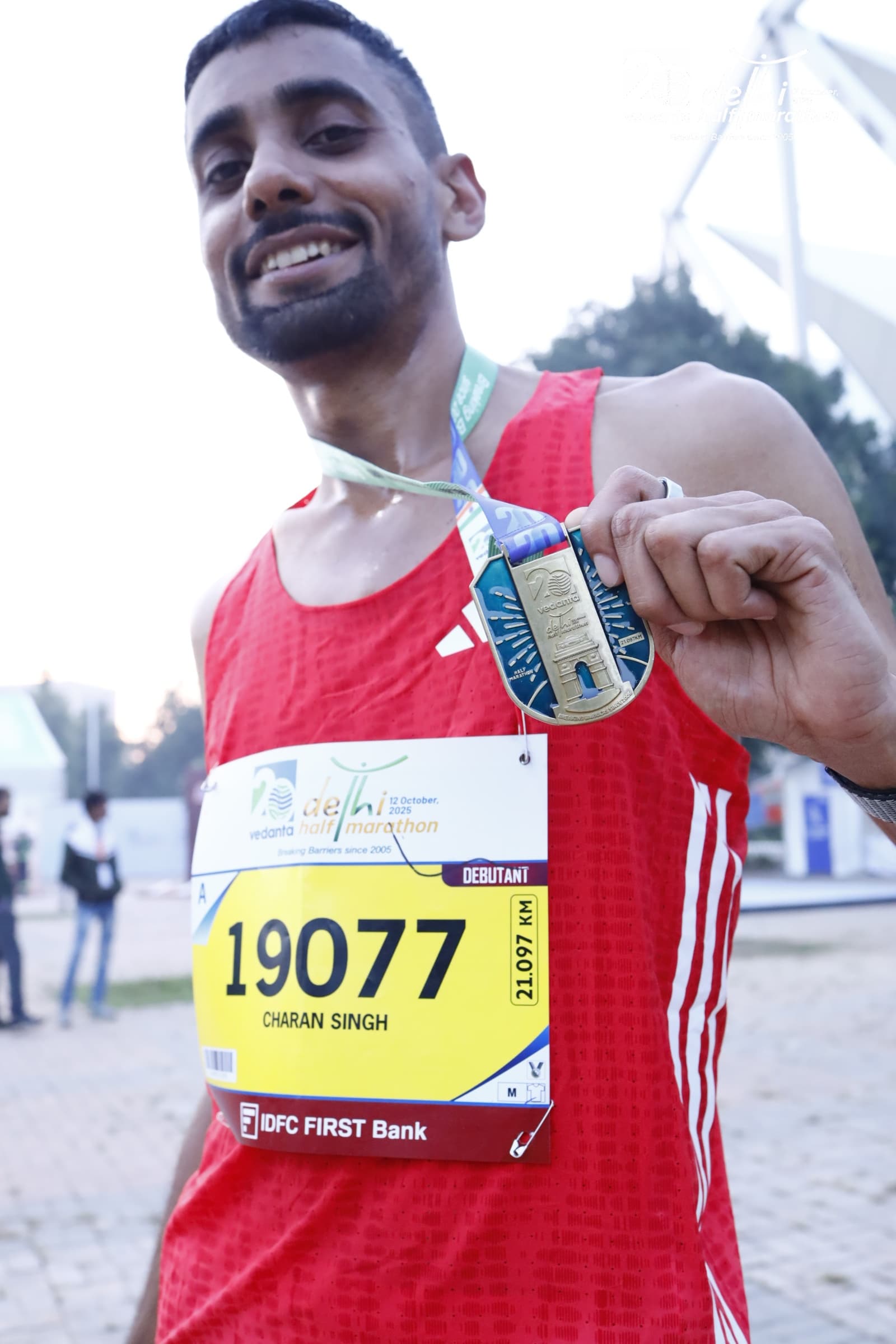 Charan Singh with his finisher medal, Vedanta Delhi Half Marathon 2025
